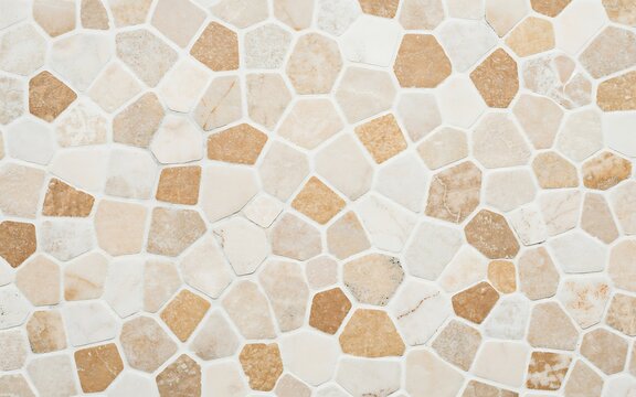 Natural stone wall cladding with irregular beige and tan tiles