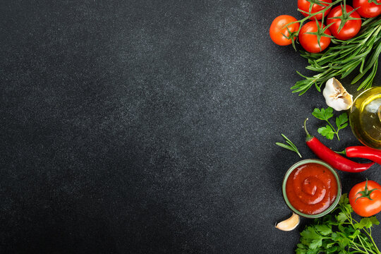 Black empty plate, Fresh herbs, spices and vegetables.