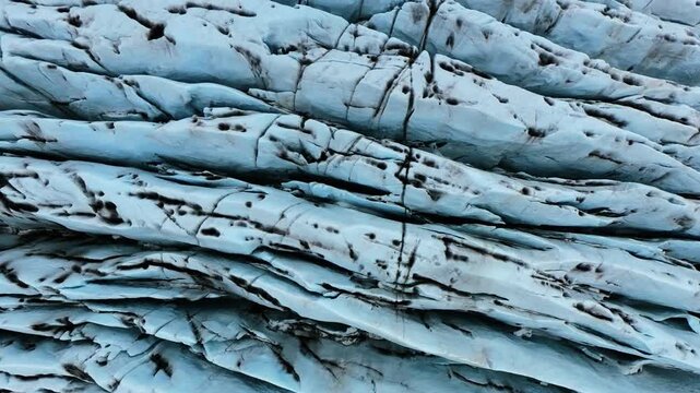 Aerial Drone Glacier Ice Ridges Volcanic Ash Streaks Iceland Cinematic Movement
