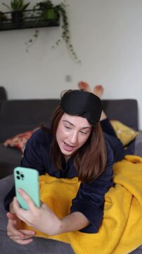 Vertical screen Social media is the first stop after waking as a young woman records a cheerful morning story proving her day begins with the phone before anything else