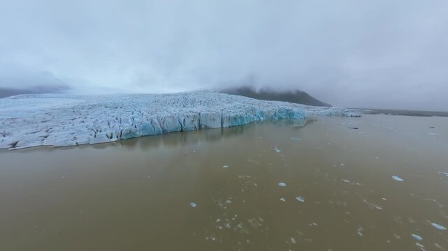 Aerial Drone Approaches Glacier Wall Fjalls&aacute;rl&oacute;n Iceland Cinematic Reveal