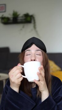 Vertical screen Starting every morning with coffee instead of breakfast becomes an unhealthy habit as a sleepy young woman reaches for caffeine before fully waking up