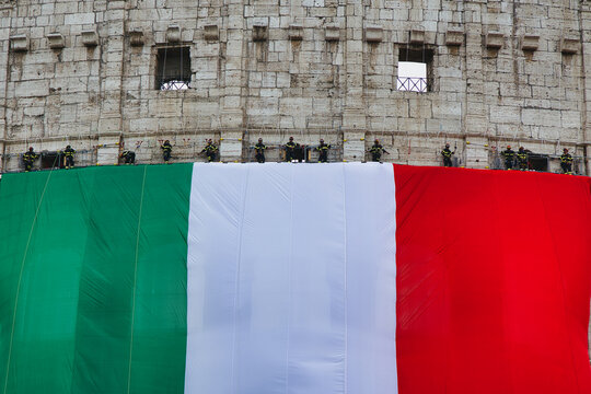 Italy national day celebration at the Colosseum with Italian flag waving. Historic Roman amphitheater displaying patriotism during June 2nd parade...