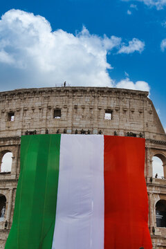 Italy national day celebration at the Colosseum with Italian flag waving. Historic Roman amphitheater displaying patriotism during June 2nd parade...