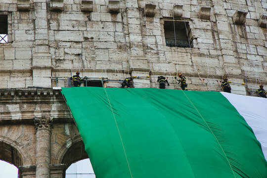 Italy national day celebration at the Colosseum with Italian flag waving. Historic Roman amphitheater displaying patriotism during June 2nd parade...