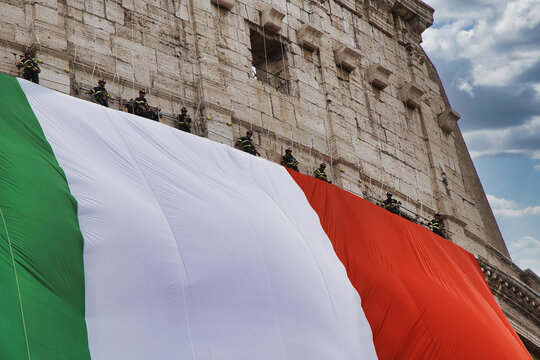 Italy national day celebration at the Colosseum with Italian flag waving. Historic Roman amphitheater displaying patriotism during June 2nd parade...