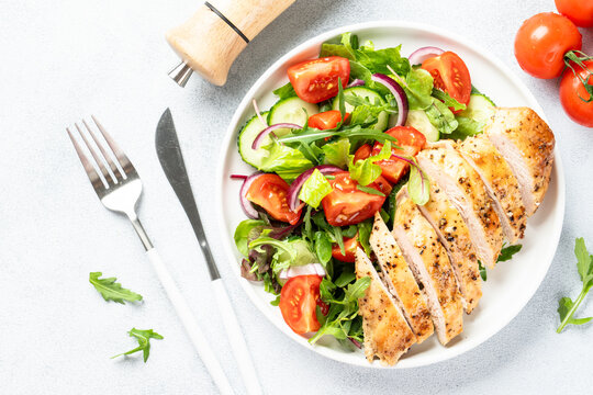 Green salad with leaves, tomatoes, cucumber.