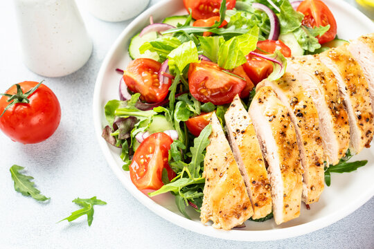 Green salad with leaves, tomatoes, cucumber.