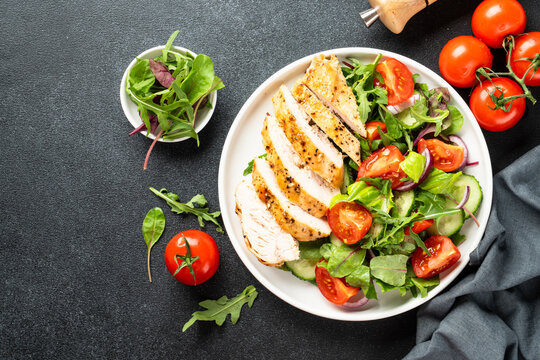 Healthy food plate. Meat salad with chicken fillet and fresh vegetables.
