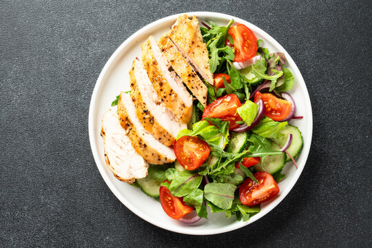 Healthy food plate. Meat salad with chicken fillet and fresh vegetables.