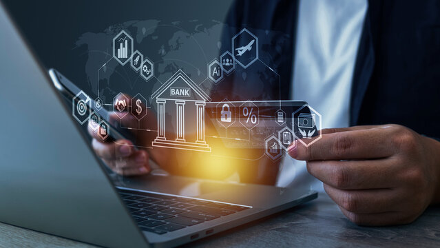 A person uses a laptop with digital banking icons floating around, representing online banking, financial technology, AI, cybersecurity, investment, and digital transformation in the banking industry.