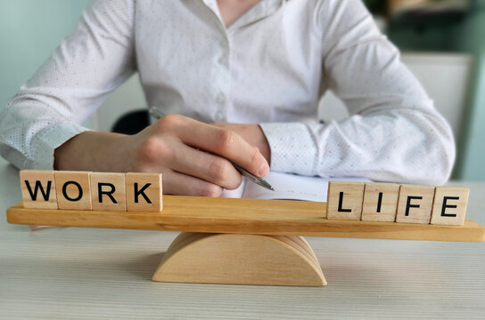 Work and life balanced on a scale made of wooden blocks