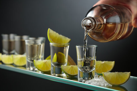 Tequila shots with salt and lime slices.