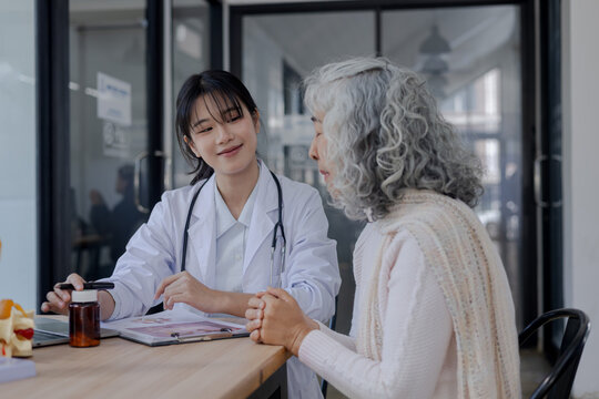 Friendly doctor recommending medication to senior patient