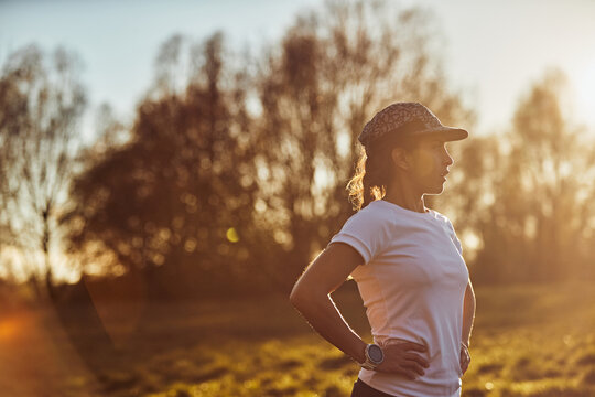 Woman Resting After Run In Warm Sunset Light