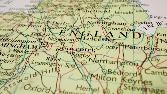 Gliding over England to London on a detailed  atlas map