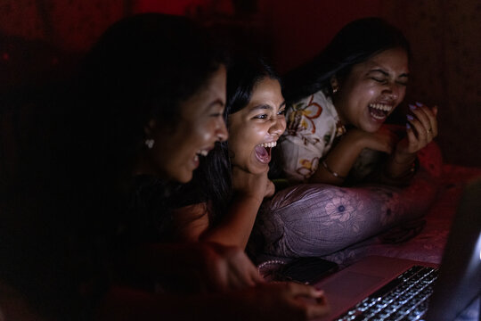 Three Young Woman enjoying movie inside home
