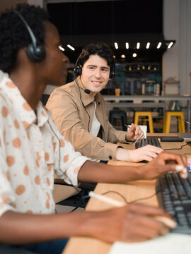 Call center agents are working together at modern office 