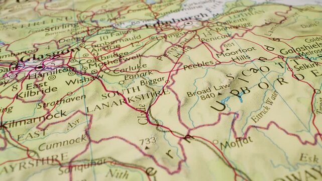 Gliding over Scotland to Edinburgh on a detailed atlas map