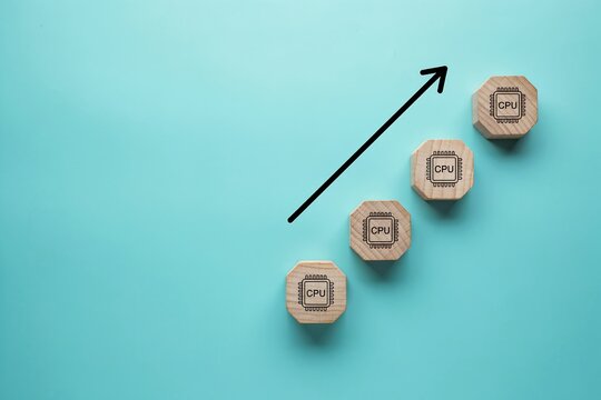 Wooden blocks with microchip icons forming a growth chart. Tech business success concept.