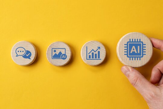 Hand holding wooden block with AI icon. Digital transformation and machine learning concept.