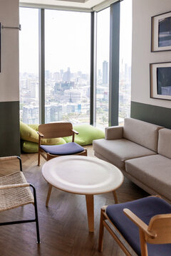 Modern Lounge Area With City View and Natural Light During Daytime