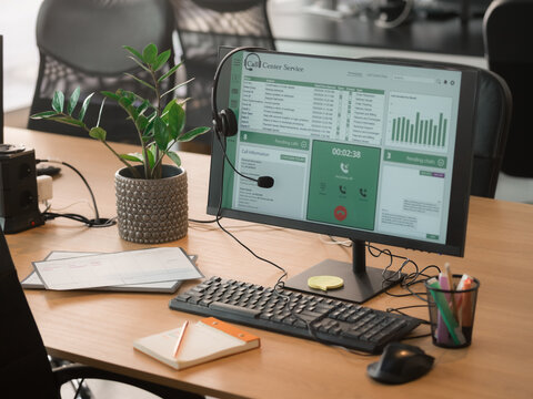 Call Center Workspace With Computer and Plants in Office
