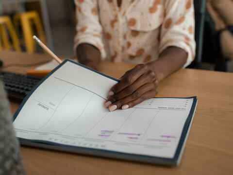 Woman filling document at her desk
