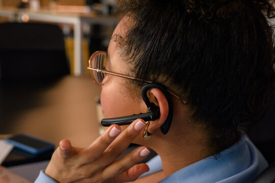 Woman using hands-free device at work 