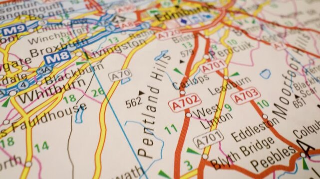 Road network to Edinburgh gliding view over an atlas map, Scotland travel route