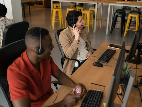 Call center workers smiling while communicating with clients 
