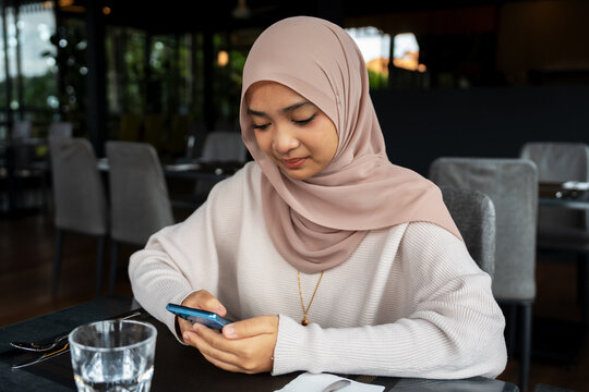 Young women texting on smartphone Sabah Malaysia