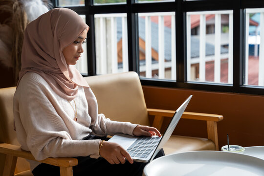 Woman using laptop by the window