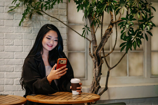 Japanese using phone at Tokyo cafe at night
