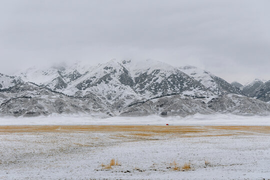 Winter Prairie, Mountains, and Red Cabin.