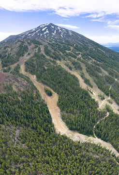 Mt. Bachelor and its meandering ski trails rise from the Deschutes National Forest in Oregon. This iconic volcanic mountain is part of the Cascade Range and just 22 miles from Bend.