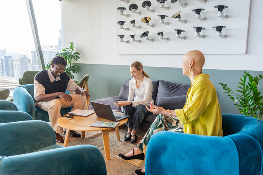 Group Discusses Ideas in Modern Meeting Space in the City