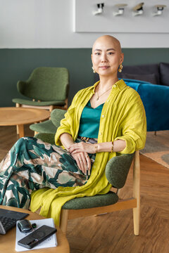 Woman Sitting in a Chair Wearing a Yellow Outfit in a Modern Room