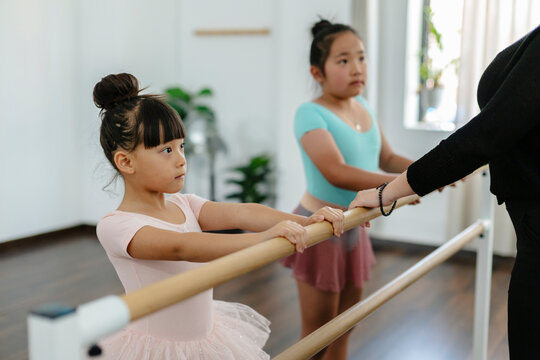 Young asian girl learning ballet dancing at studio