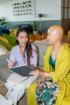 Two Women Discuss Ideas in a Modern Office Setting