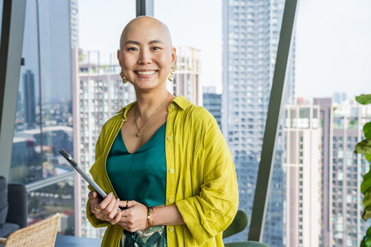 Smiling Woman Stands in Modern Office With City View