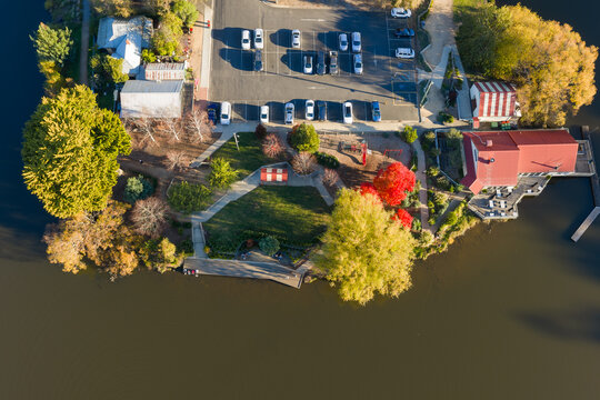 Parkland and carpark with colored Fall trees on the shores of a lake