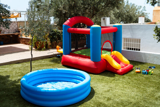 Backyard fun with inflatable bounce house and paddling pool