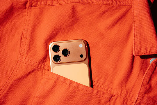 Smartphone In Orange Jacket Pocket