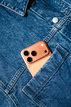 Copper Colored Smartphone In Denim Jacket Pocket