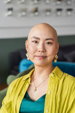 Portrait of a Bald Fancy Woman in Modern Space With Vibrant Colors