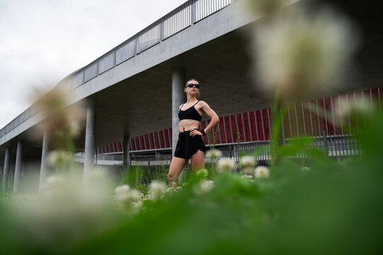 Female runner surrounded by greenery in urban location
