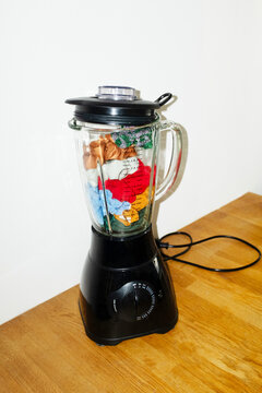 Conceptual image of blender filled with colourful glitter fabrics