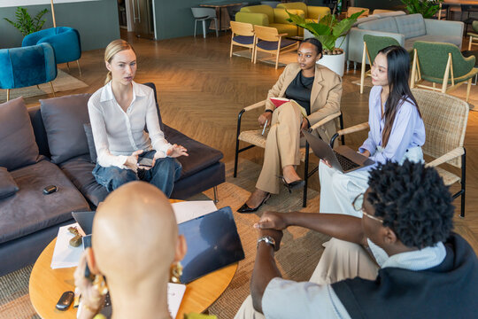 Group Discusses Ideas in Office Space During Work Hours