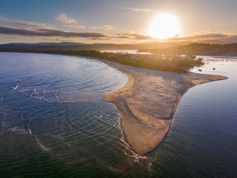 Golden sunset over a sand spit off an coastal beach